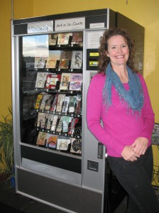 Nancy Morrison stands next to her snack machine dubbed Vincent Art à la Carte, which sells art from 15 Lewiston-Clarkston artists. An artist herself, Morrison was inspired by Art-O-Mats to sell the artwork inside Roosters WaterFront Restaurant in Clarkston.
